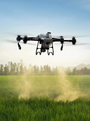 An industrial Agriculture Spraying Drone flying over a vibrant green crop field delivering precision liquid pesticide treatment via automated downward spray nozzles.